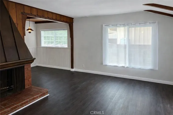 a kitchen with wooden floors and stainless steel appliances