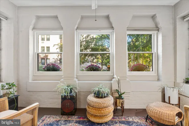 a dining room with furniture and wooden floor