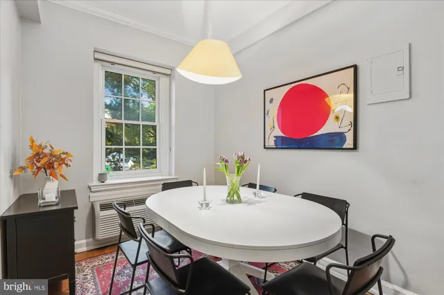 a dining room with table and chairs