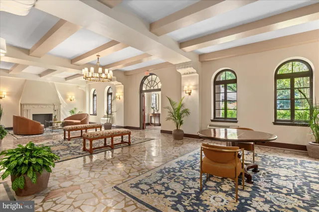 a living room with furniture chandelier and a fireplace