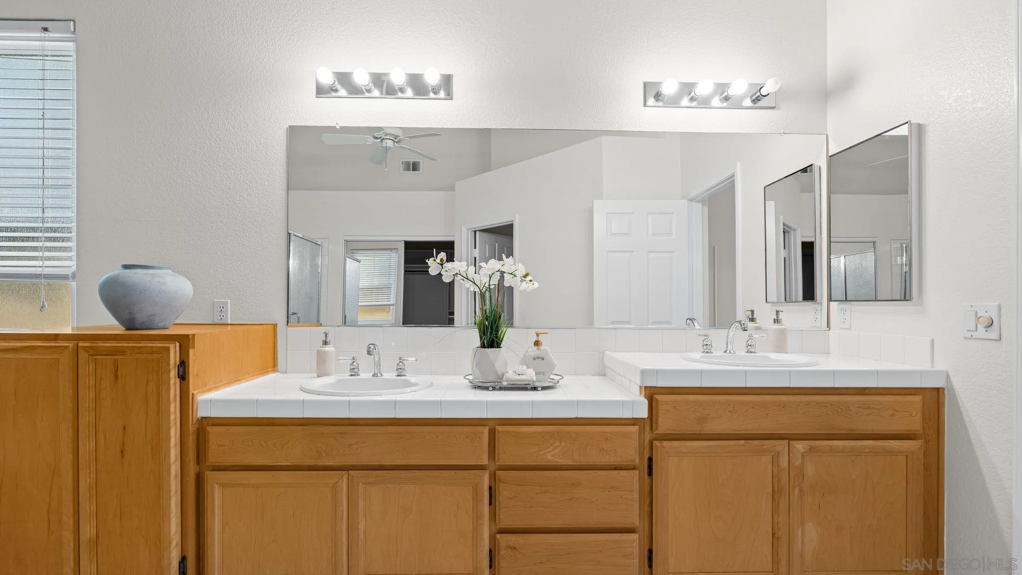1783 Medinah Road San Marcos, CA 92069 - Photo 17 of 39 a bathroom with a double vanity sink and a mirror
