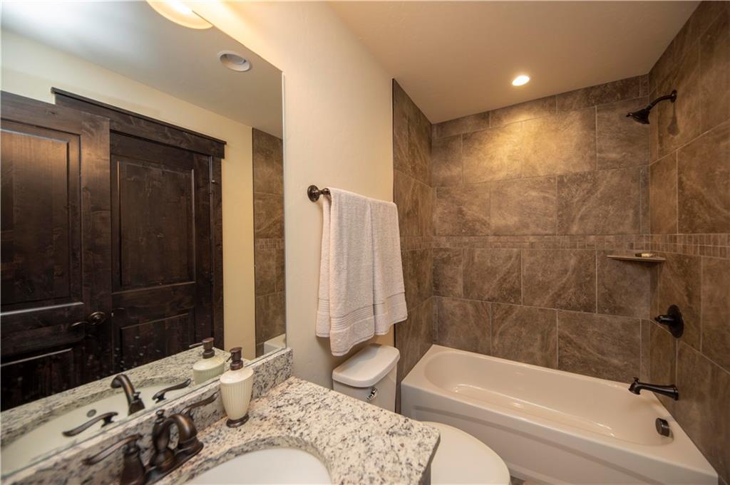 687 Independence Road Keystone, CO 80435 - Photo 14 of 26 a bathroom with a granite countertop sink toilet and shower