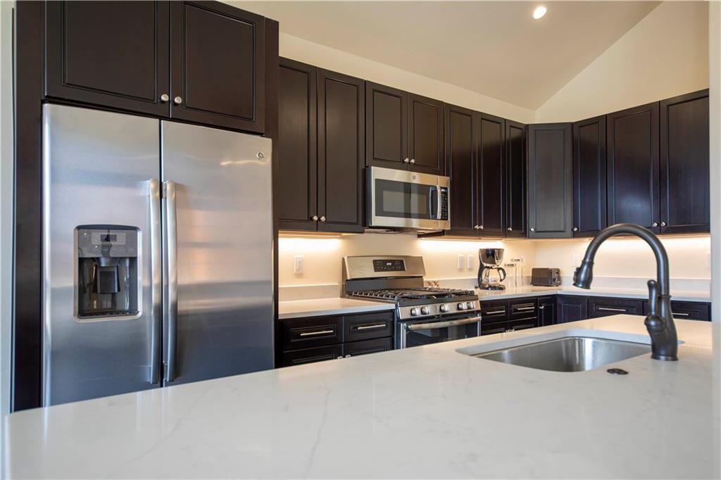 687 Independence Road Keystone, CO 80435 - Photo 6 of 26 a kitchen with granite countertop a refrigerator and a sink