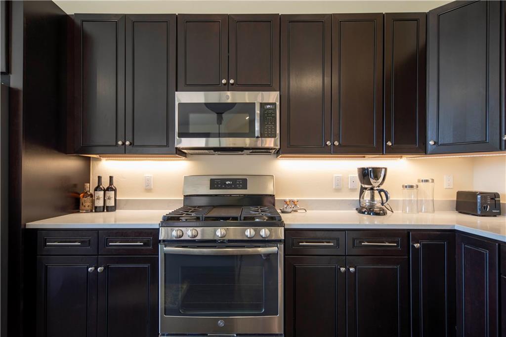 687 Independence Road Keystone, CO 80435 - Photo 7 of 26 a kitchen with a stove a microwave a sink and cabinets