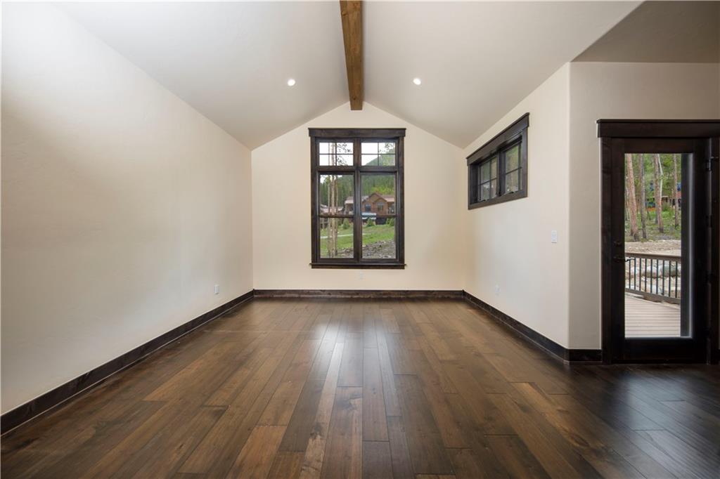 687 Independence Road Keystone, CO 80435 - Photo 8 of 26 an empty room with wooden floor and windows