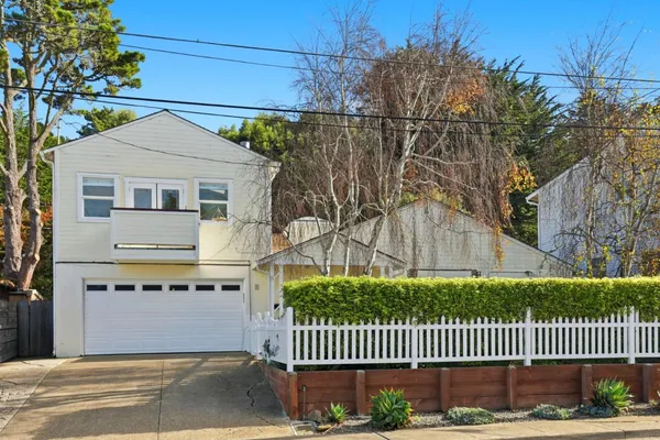 a front view of a house with a garden
