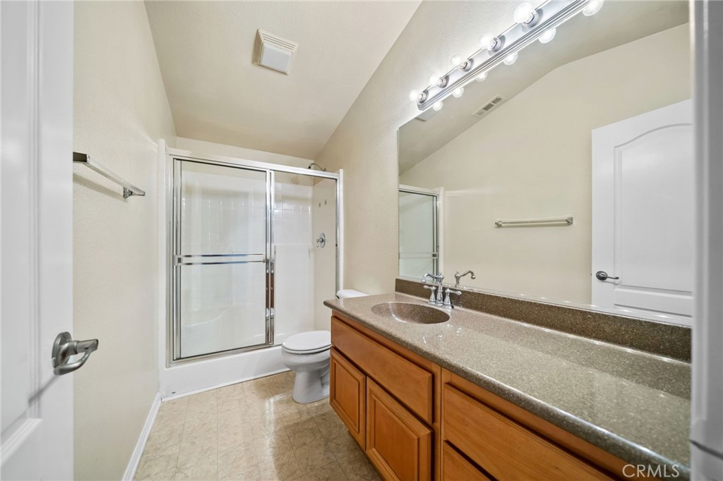 3175 Sand Pine Trail Hemet, CA 92545 - Photo 27 of 31 a bathroom with a sink a large mirror and shower