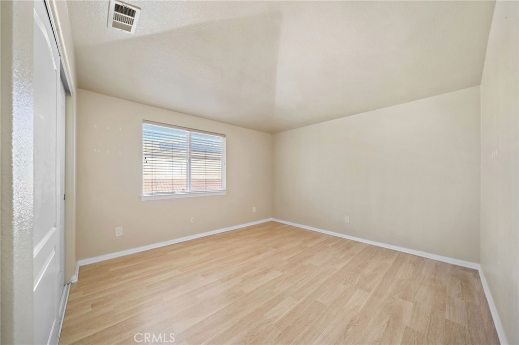 3175 Sand Pine Trail Hemet, CA 92545 - Photo 28 of 31 an empty room with wooden floor and windows