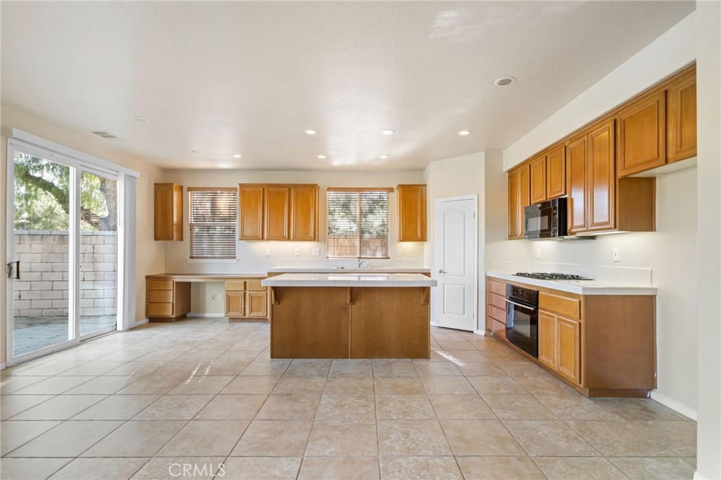 3175 Sand Pine Trail Hemet, CA 92545 - Photo 9 of 31 a large kitchen with stainless steel appliances granite countertop a stove top oven a sink and dishwasher a oven with granite countertops