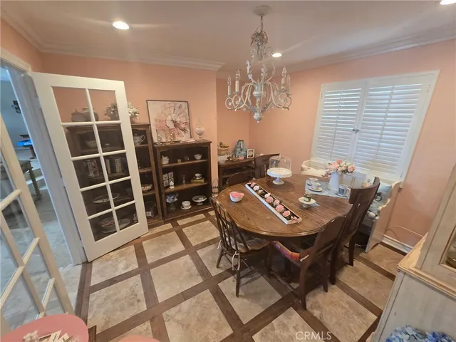 a view of a dining room with furniture and chandelier