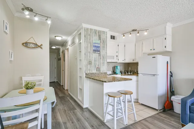 a kitchen with a table and chairs in it