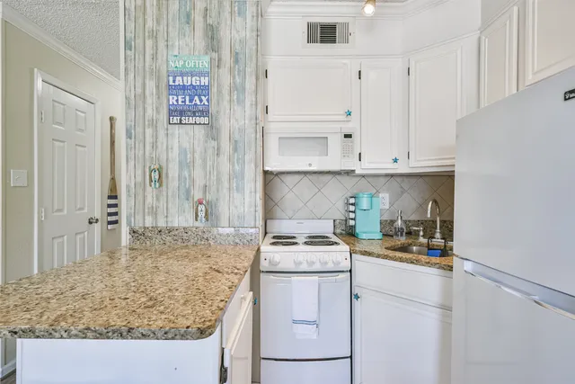 a kitchen with a sink stove and cabinets