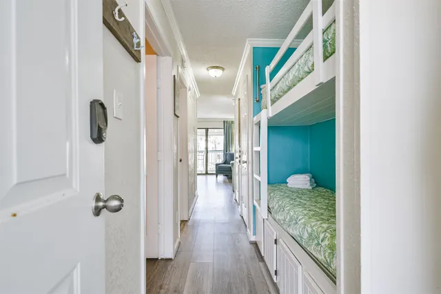a view of a hallway with wooden floor and staircase