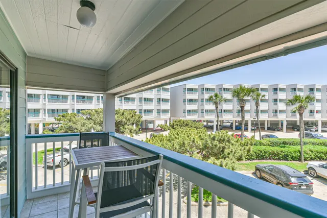a view of a porch with furniture and garden