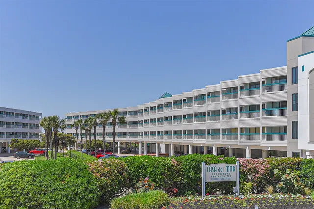 a view of a building with many windows and a yard