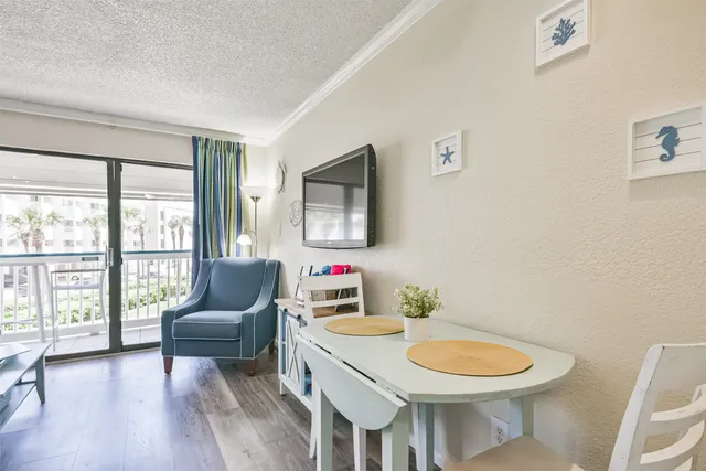 a living room with furniture a rug a lamp and a large window