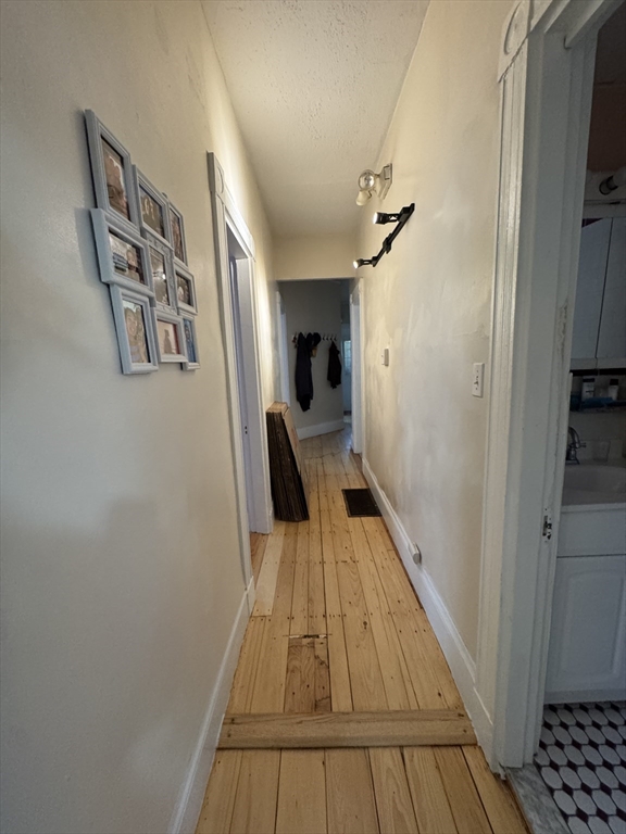 5 Spring Park Avenue, Unit 1 Boston, MA 02130 - Photo 15 of 24 a view of a hallway with wooden floor and staircase
