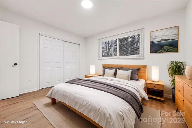 a bedroom with a bed and a potted plant