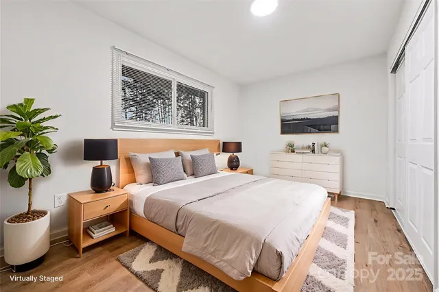 a bedroom with a bed and a painting on the wall