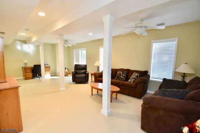 a living room with furniture and a chandelier