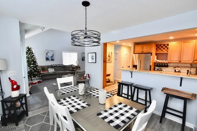 a very nice looking dining room with a large window table and chairs