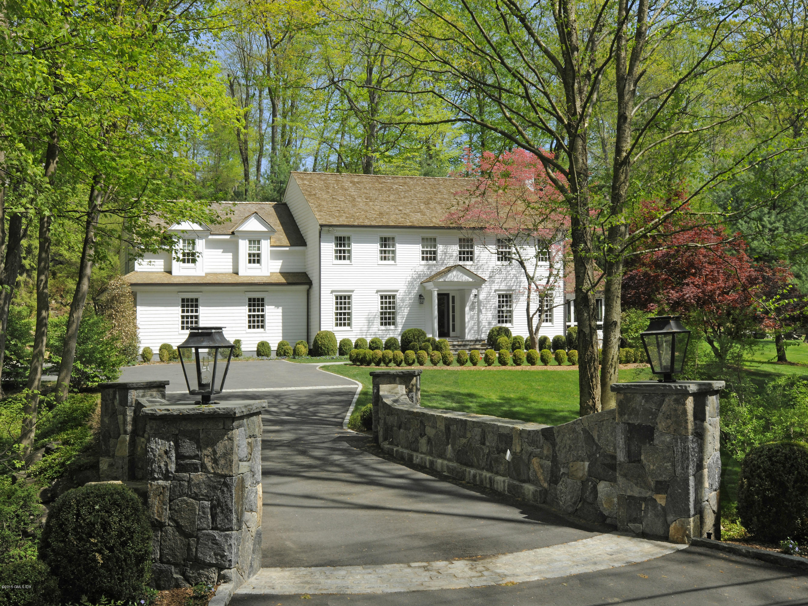 29 Butternut Hollow Road Greenwich, CT 06830 - Photo 2 of 29 a front view of a house with garden and trees