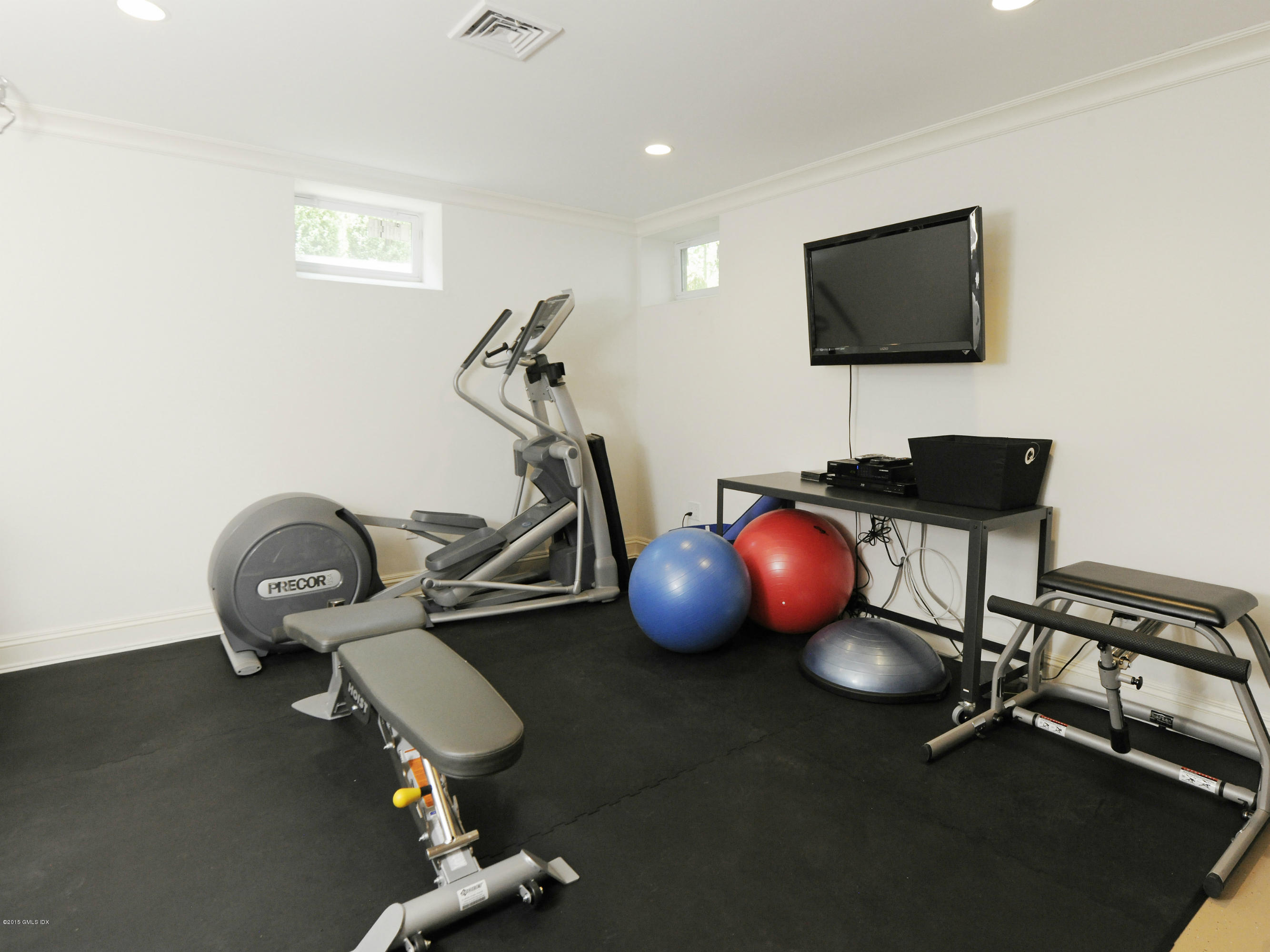 29 Butternut Hollow Road Greenwich, CT 06830 - Photo 22 of 29 a room with wooden floor and gym equipment