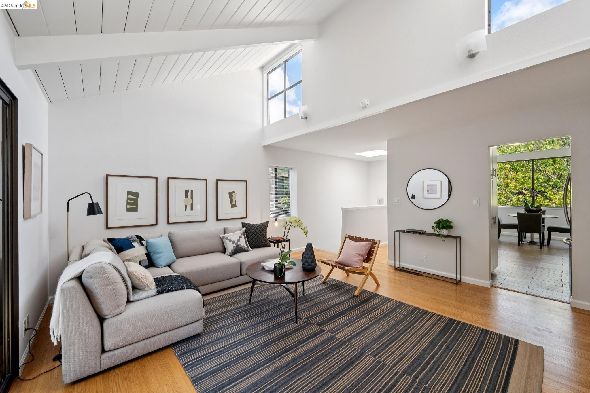 1340 Henry Street Berkeley, CA 94709 - Photo 12 of 52 Vaulted ceiling with exposed white beams and wood-finish flooring
