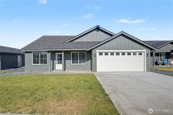 a front view of a house with a yard and garage