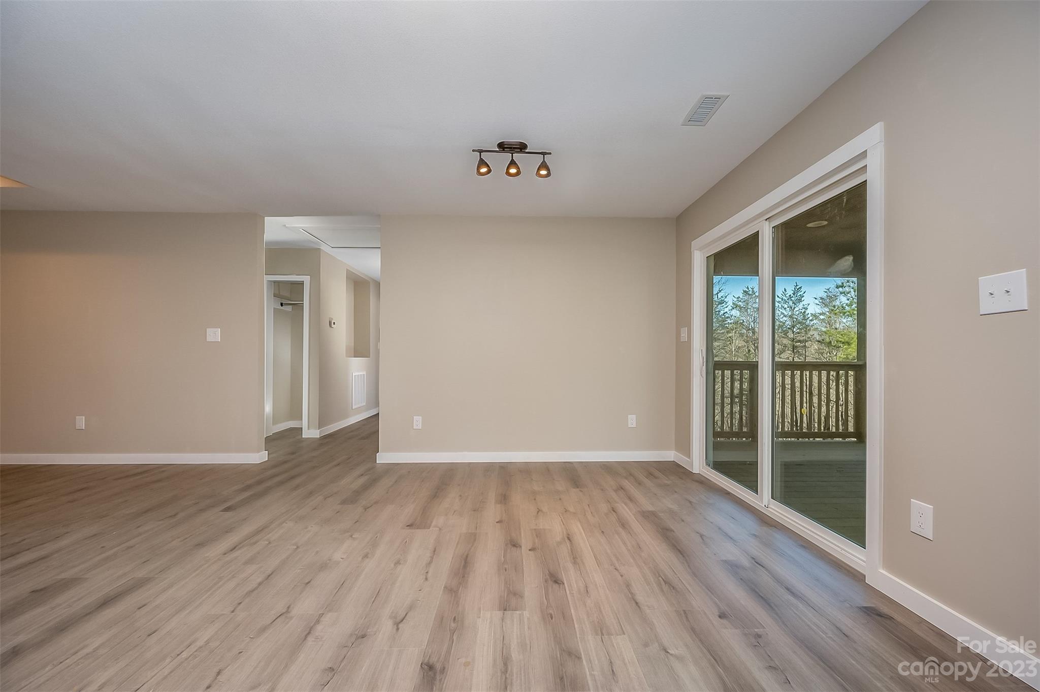 306 Observation Ridge Rutherfordton, NC 28139 - Photo 12 of 36 a view of an empty room with wooden floor and a window
