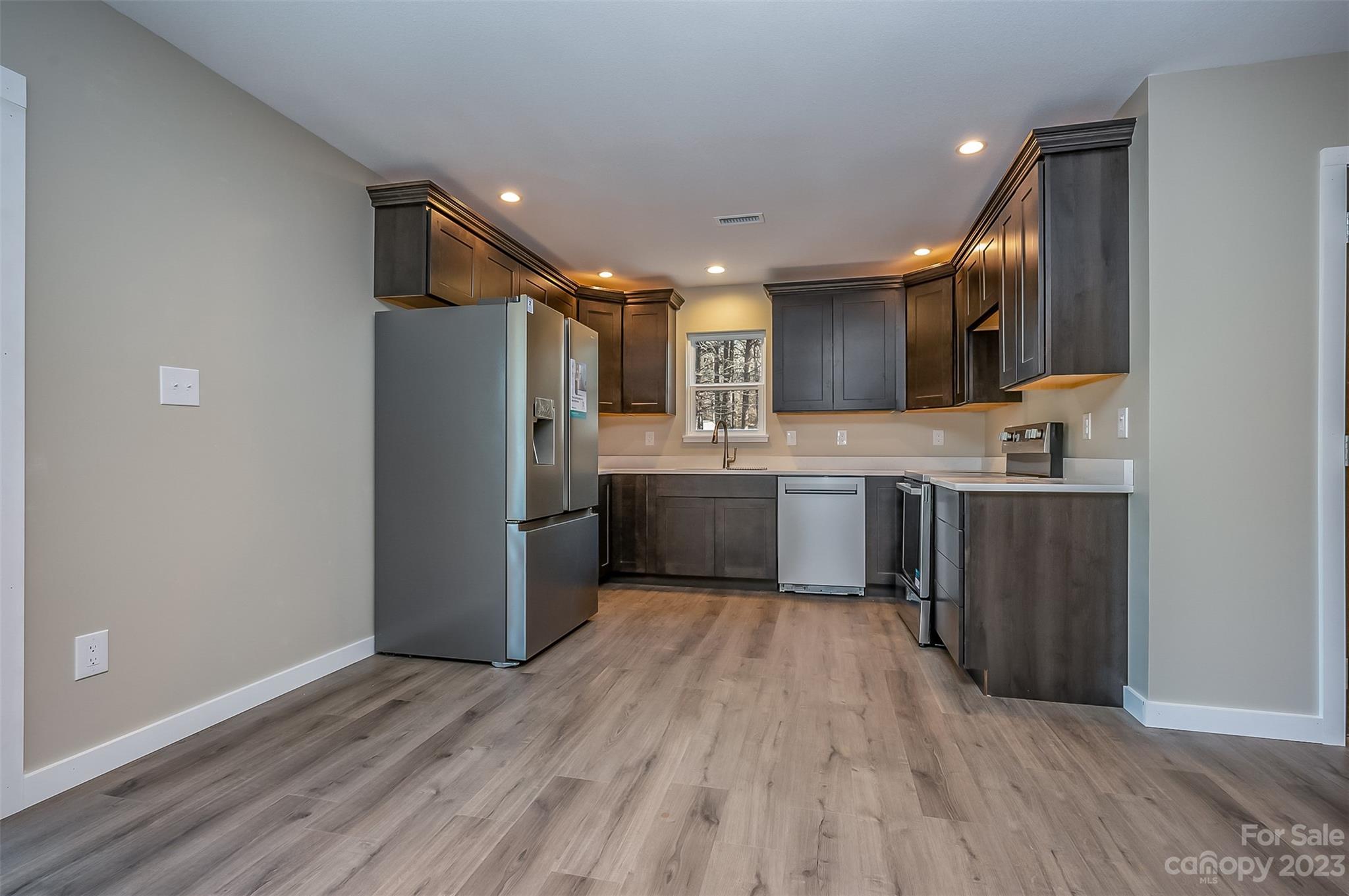 306 Observation Ridge Rutherfordton, NC 28139 - Photo 10 of 36 a kitchen with a sink a refrigerator and cabinets