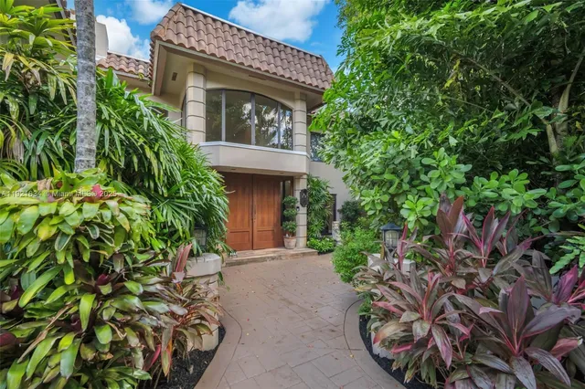 a front view of a house with a yard and a garage