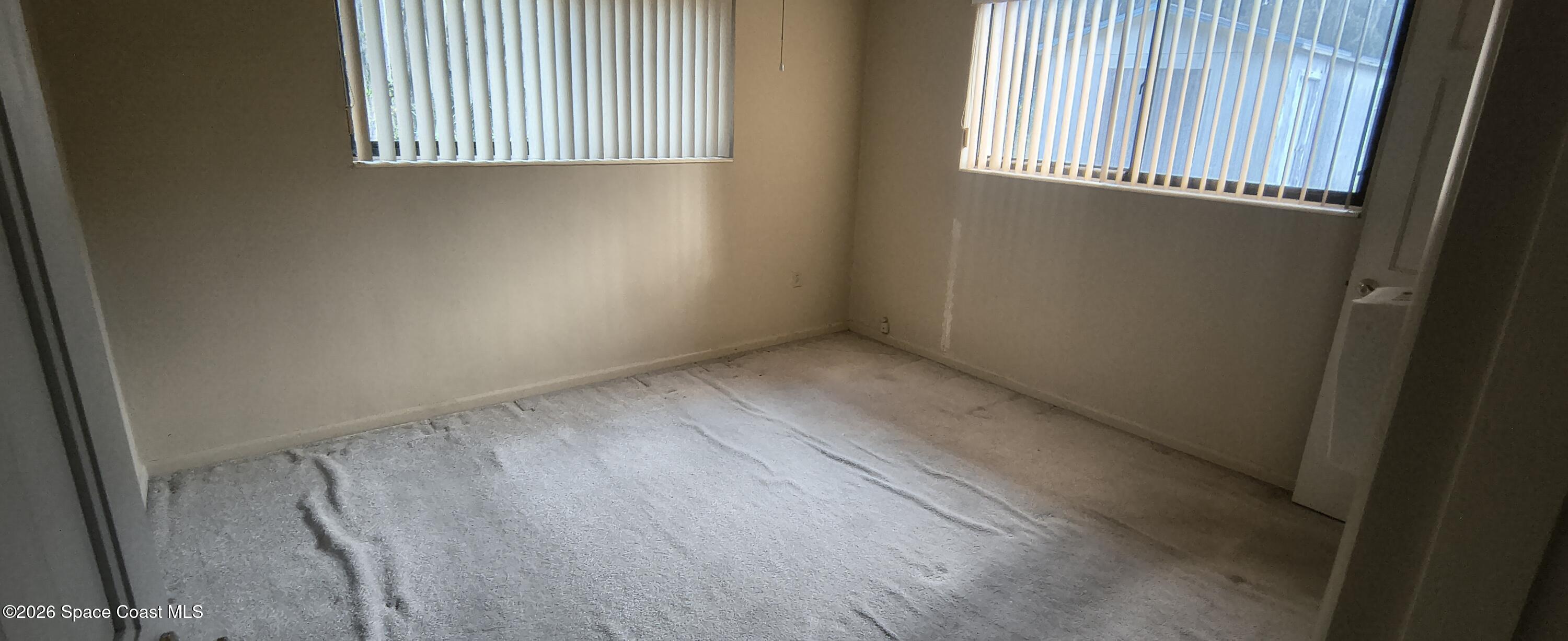 801 Espanola Way Melbourne, FL 32901 - Photo 13 of 18 an empty room with windows