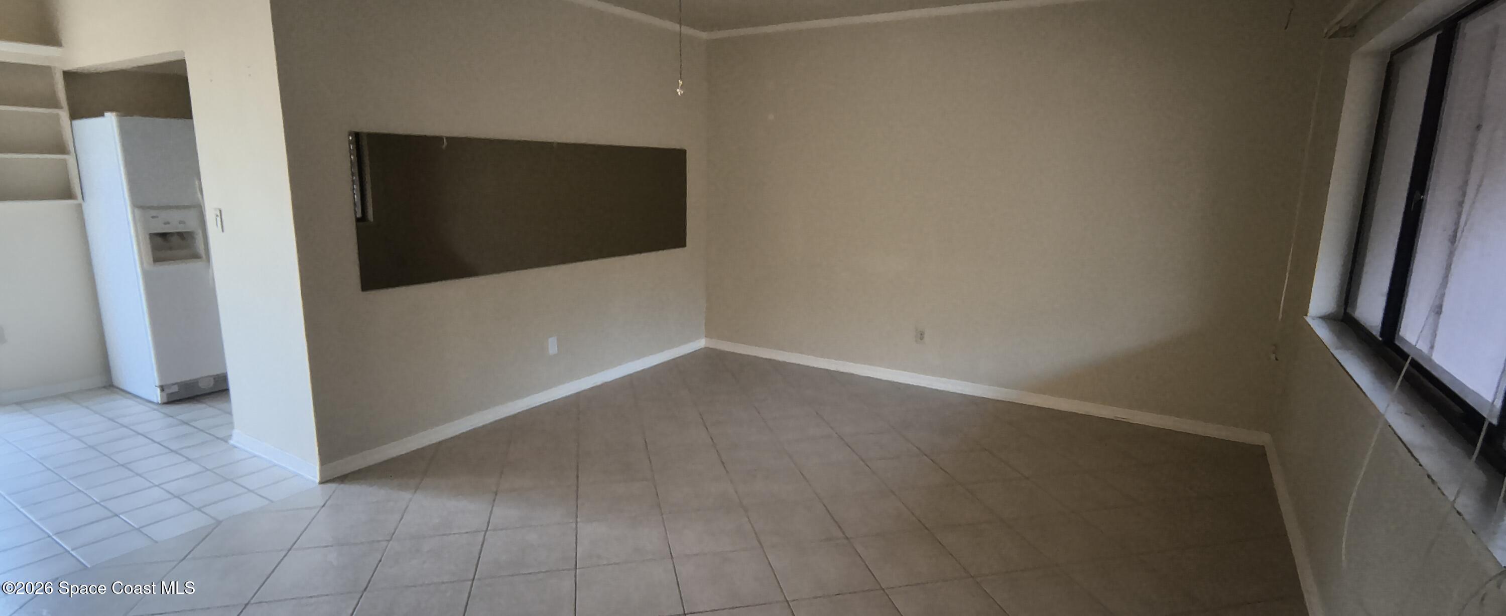 801 Espanola Way Melbourne, FL 32901 - Photo 17 of 18 a view of a livingroom with an empty space and a hallway