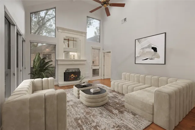 a living room with furniture a fireplace and a large mirror
