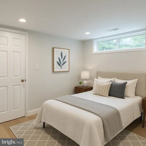 a bedroom with a bed and a painting on the wall