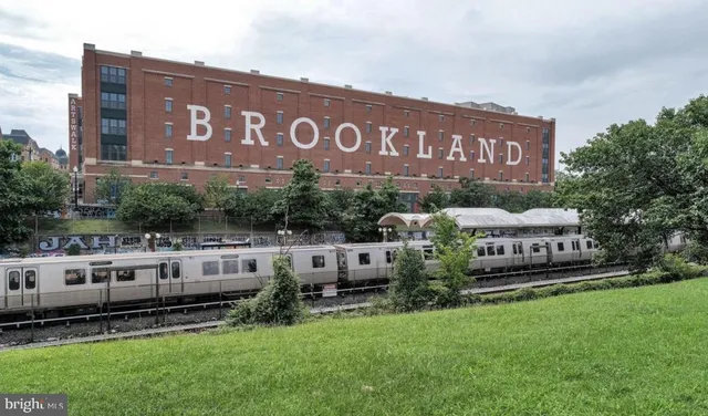 a view of a house with a garden and bench