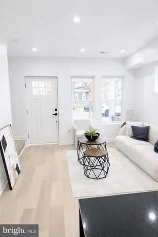 a living room with furniture window and wooden floor