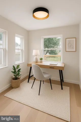 a dining room with wooden floor and a potted plant