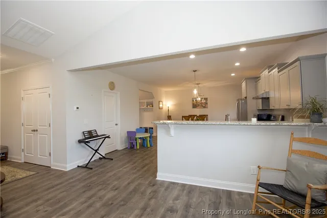 a bedroom with a bed and painting on the wall