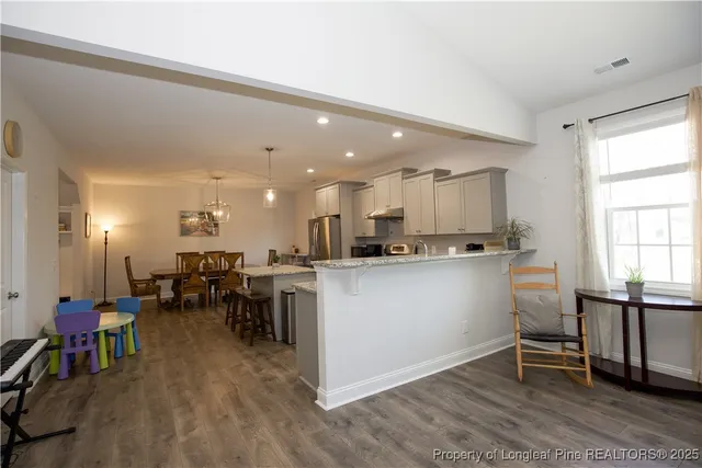 a bedroom with a bed and a flat tv screen on wall