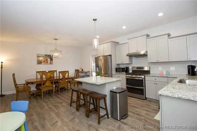 a kitchen with a stove a sink and a refrigerator