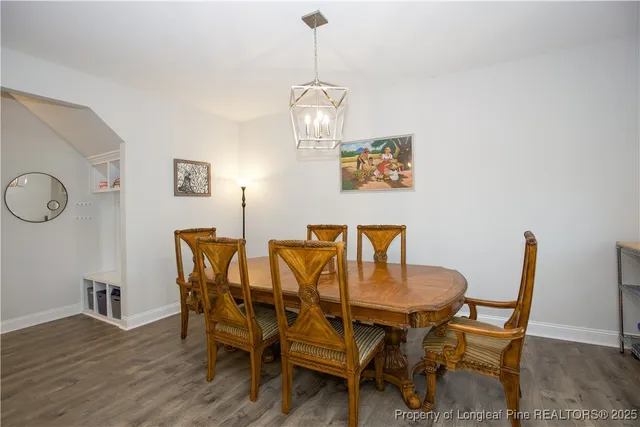 a kitchen with a refrigerator a microwave oven a sink dishwasher with a dining table and chairs