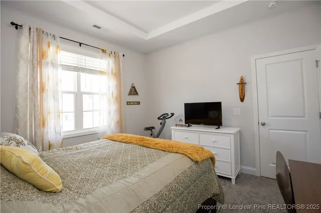 a bedroom with a bed and a potted plant