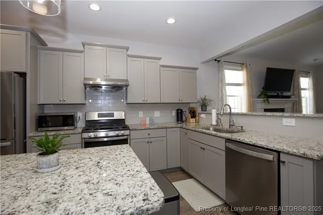 a bedroom with furniture and a wooden floor