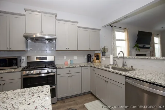 a bathroom with a sink mirror vanity and toilet