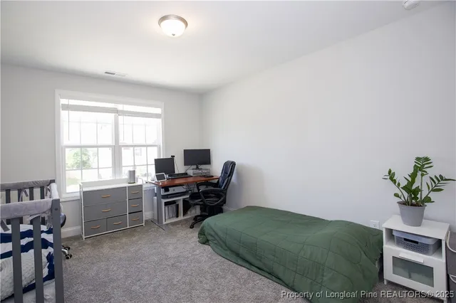 a view of a patio with a table chairs and a floor to ceiling window