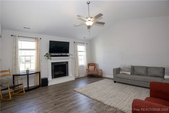 a kitchen with stainless steel appliances kitchen island granite countertop a table chairs sink and cabinets