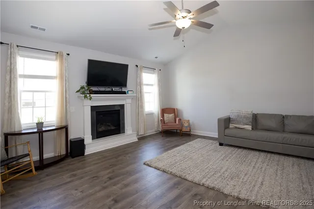 a kitchen with stainless steel appliances kitchen island granite countertop a table chairs and a refrigerator