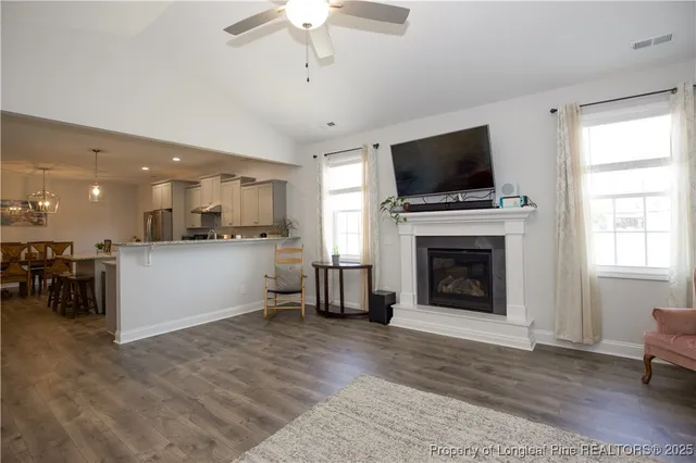 a view of a dining room with furniture wooden floor and chandelier